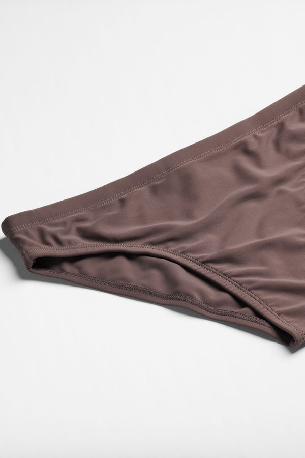 Brown swim briefs on a light gray background